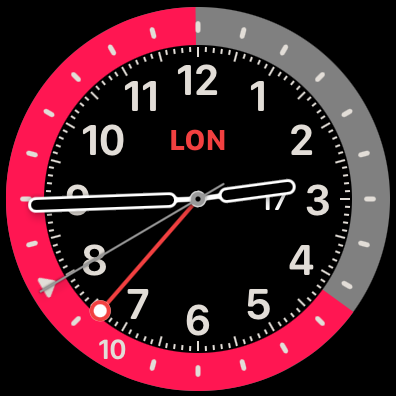 Apple Watch showing 2:44 p.m. in Los Angeles, 10:44 p.m. in London. You infer that pink is night because it is so long, or from the triangle that still marks midnight. Note that the GMT hand tracks Los Angeles time (currently UTC−8), but with midnight on top, so UTC midnight is at the eight o&rsquo;clock marker.