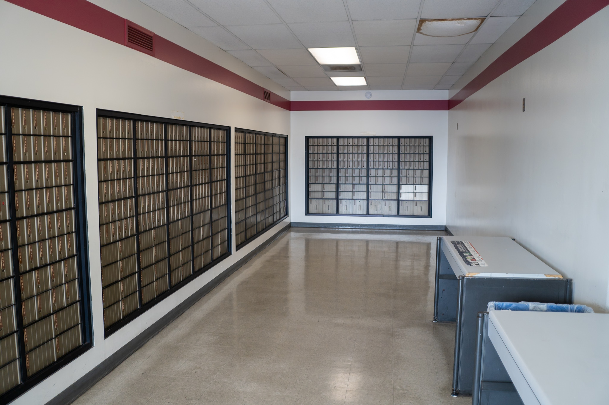 Walls of mail boxes inside of a US Postal Service office